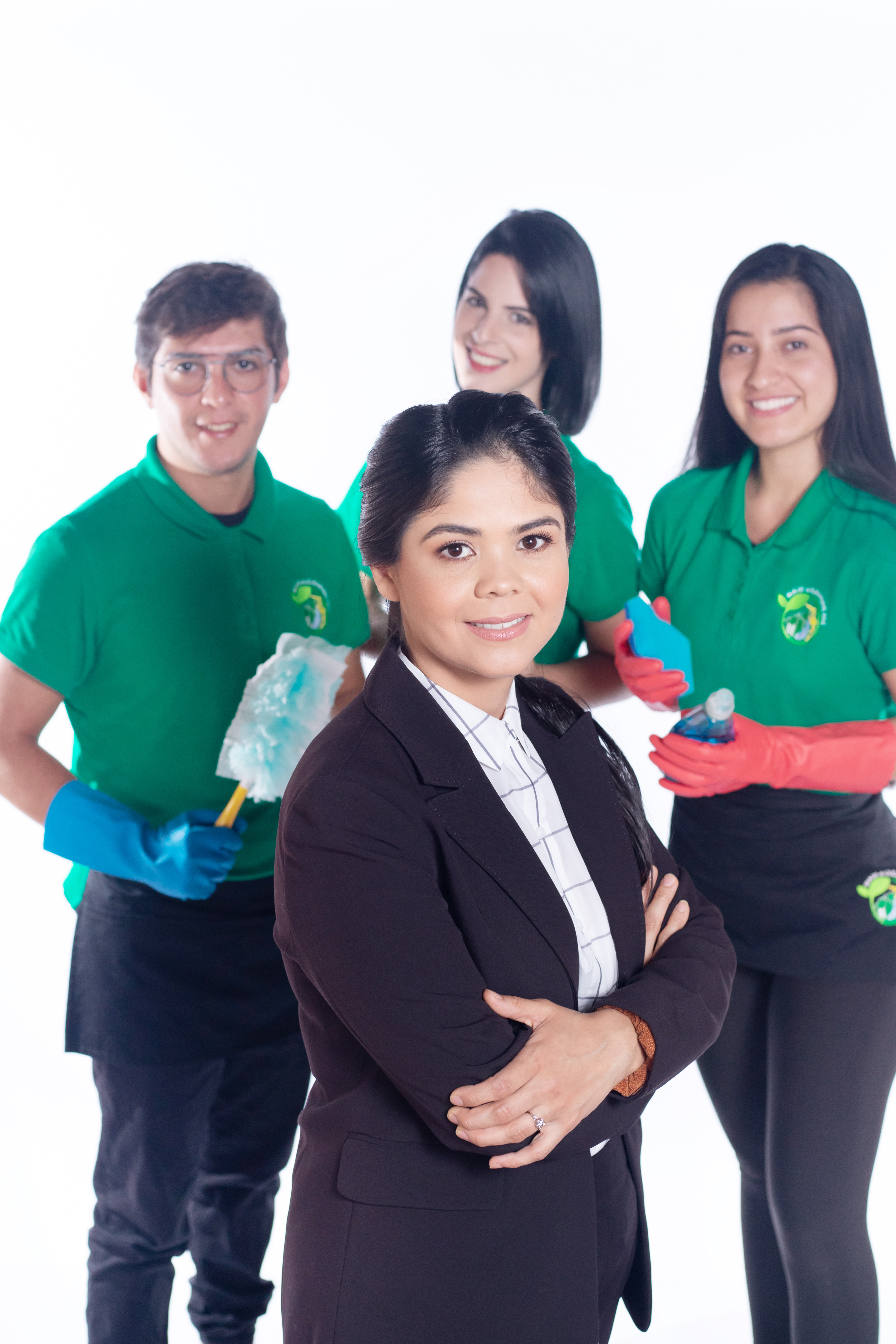A professional cleaning team from Maid 4 Cleaning, dressed in green uniforms with cleaning supplies, stands confidently behind a manager in business attire. This image represents the expert organization and cleaning services that can help transform your cluttered closet and home into a tidy, stress-free space.