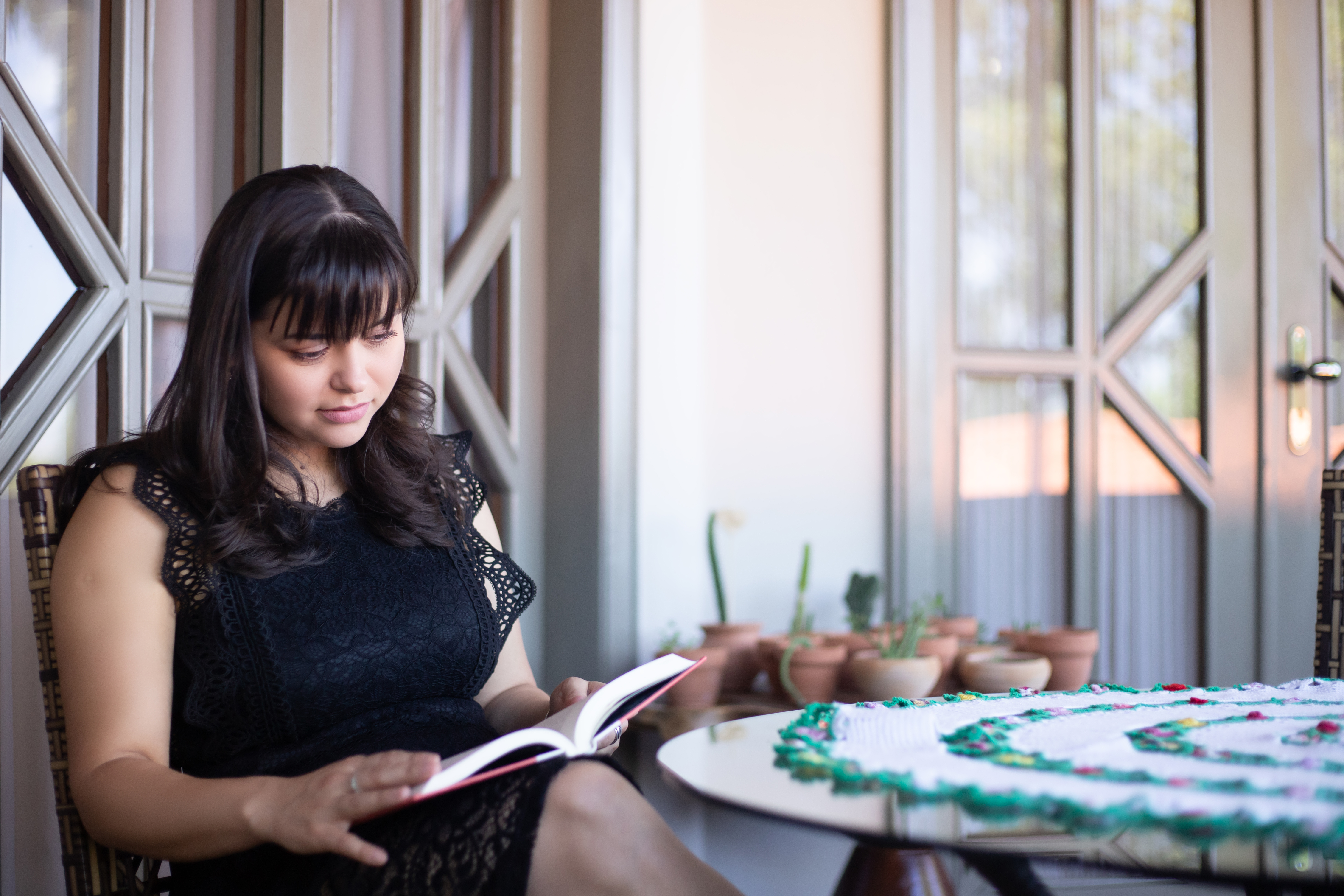 Relax and unwind this holiday season while Maid 4 Cleaning takes care of your home. A woman enjoys peaceful reading time in a clean and cozy patio, stress-free thanks to professional cleaning services.